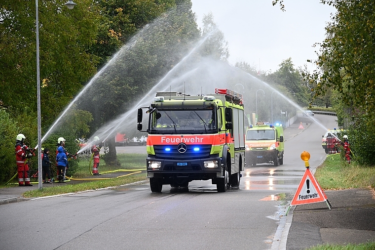 Begrüssung mit einem Wasservorhang: Das neue TLF fährt mit Blaulicht und Martinshorn durch Rifferswil. (Bild Martin Mullis)